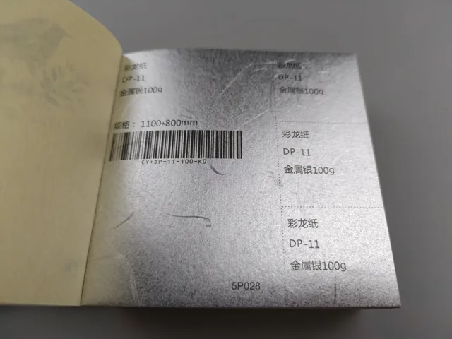 Reflective patterned surface; photographed paper sample book with original labels