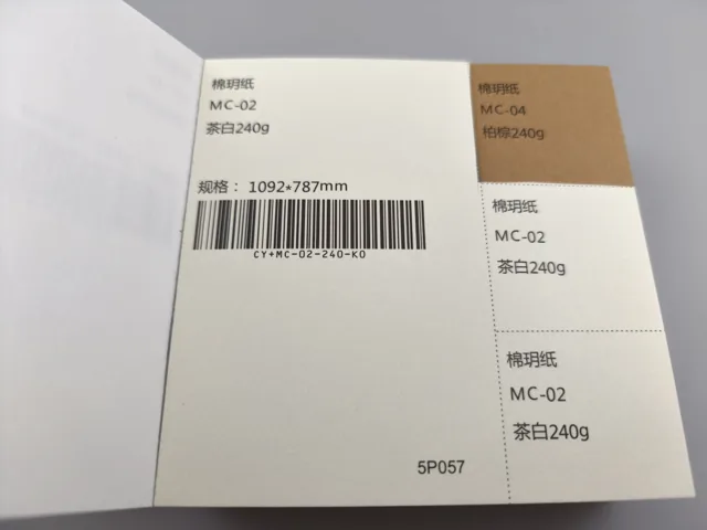 Ivory and ochre swatches; photographed paper sample book with original labels