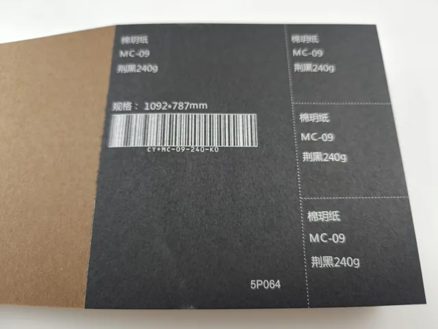 Ochre and charcoal swatches; photographed paper sample book with original labels