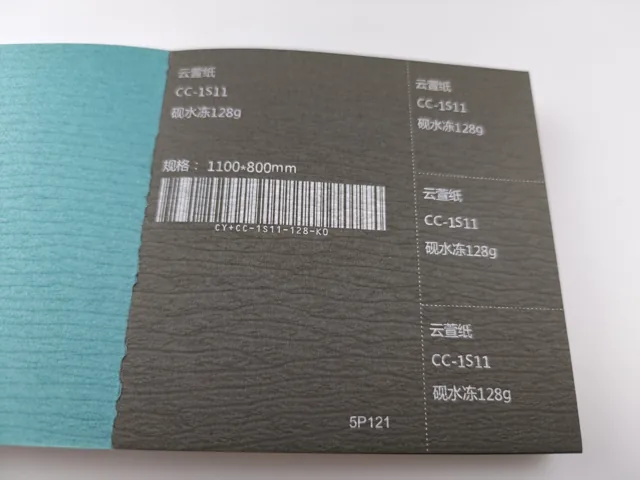 Blue and dark textured swatches; photographed paper sample book with original labels