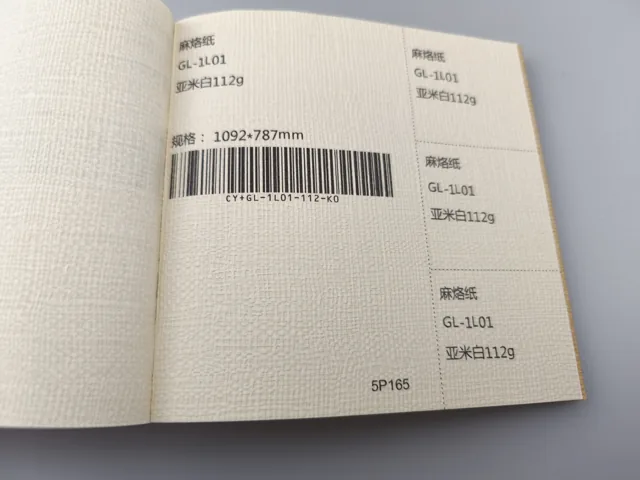 Cream woven-look texture; photographed paper sample book with original labels